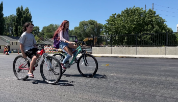 kids ridding their bikes over bridge