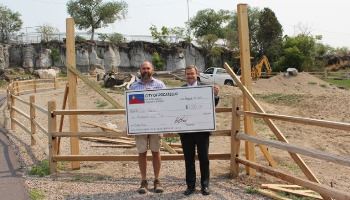 Mayor Brian Blad, right, presents Peter Pruett, Zoo Idaho Superintendent, with a $1,000 check. 