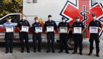 Members of “A” platoon at Fire Station #2 stand holding the seven Mission: Lifeline ® awards.